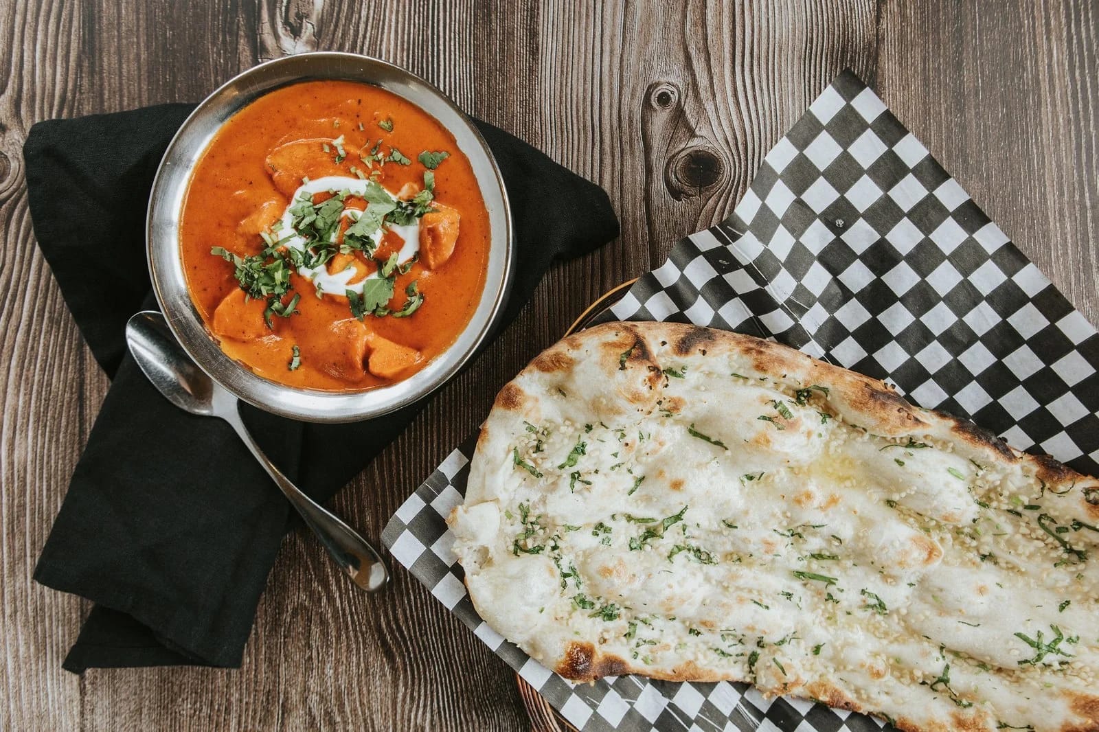 Indian dishes with naan and rice — Host India