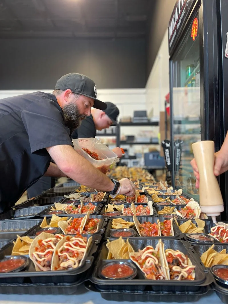 Meatings team preparing meals — Meatings BBQ Catering