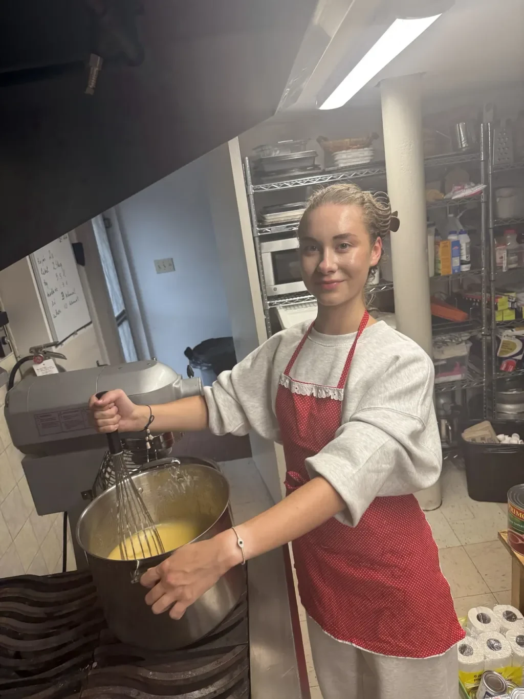 OH! Catering founder Anastasiia Stepanenko whisking batter in the kitchen