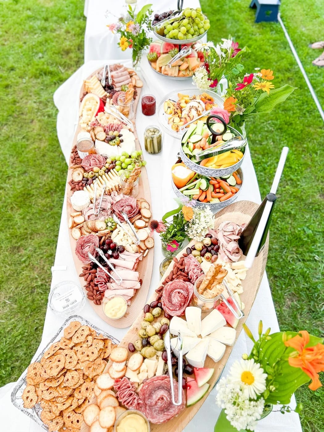 Outdoor grazing table with charcuterie and fruit by Berry & Brine