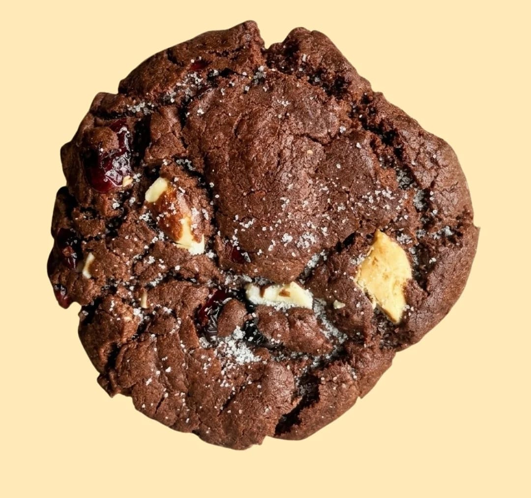Chocolate ChewyPuff cookie on a pale yellow background