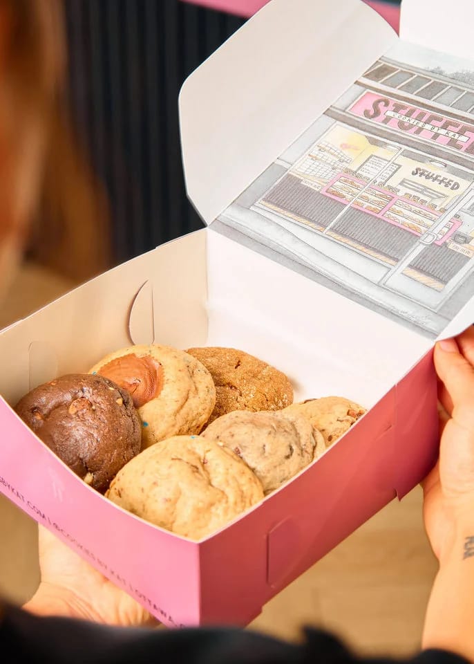 An open pink box of assorted Cookies by Kat cookies